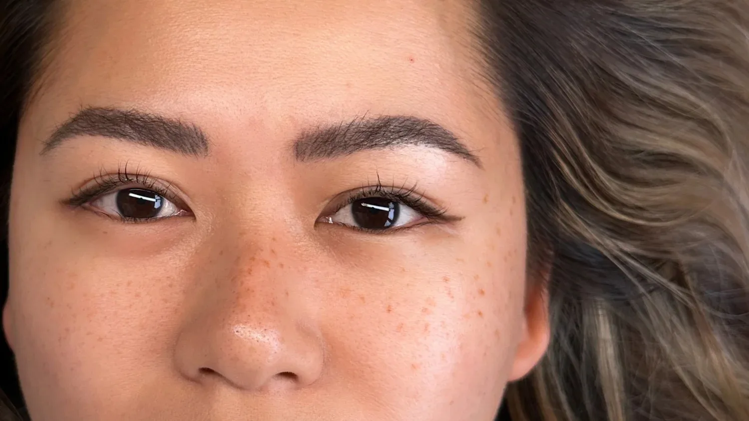 Close-up of delicate freckle tattoo result on nose and cheeks