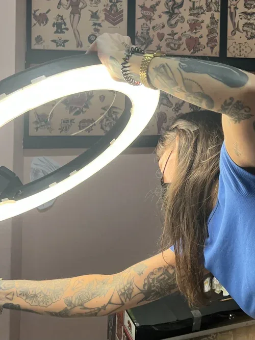 Maggie at Little Feather Cosmetic Tattoo adjusting her ring light